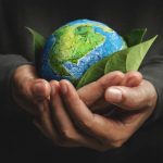 World Earth Day Concept. Green Energy, Renewable and Sustainable Resources. Environmental and Ecology Care. Hand Embracing Green Leaf and Handmade Globe